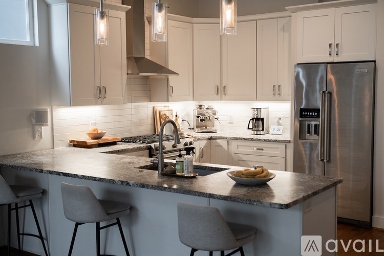 A modern kitchen with a large island and stainless steel appliances.