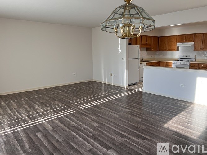 A room with a wooden floor and a chandelier.
