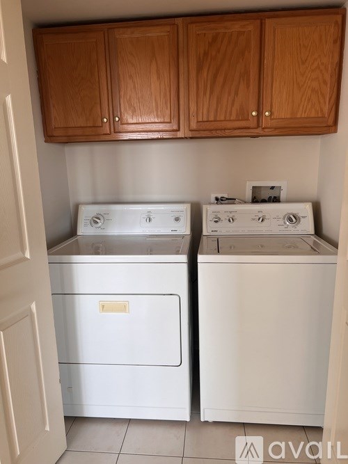 A small laundry room with a washer and dryer.