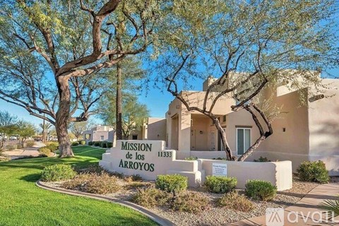The image shows a building with the sign "Mission of the Arroyos" in front of it.