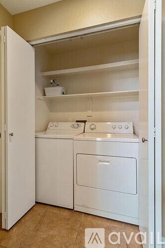 A small laundry room with a washer and dryer.
