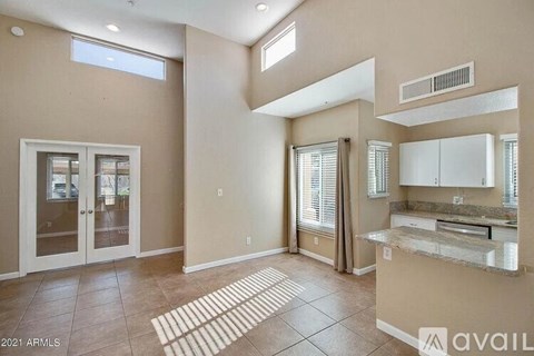 A kitchen area with a counter and cabinets is available for rent.