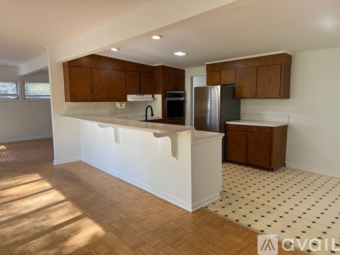 A kitchen with wooden cabinets and a white countertop.