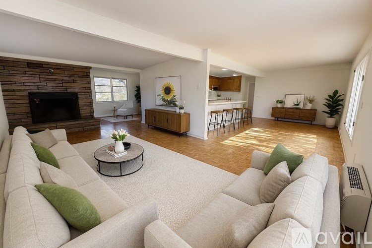 A living room with a large couch and a fireplace.