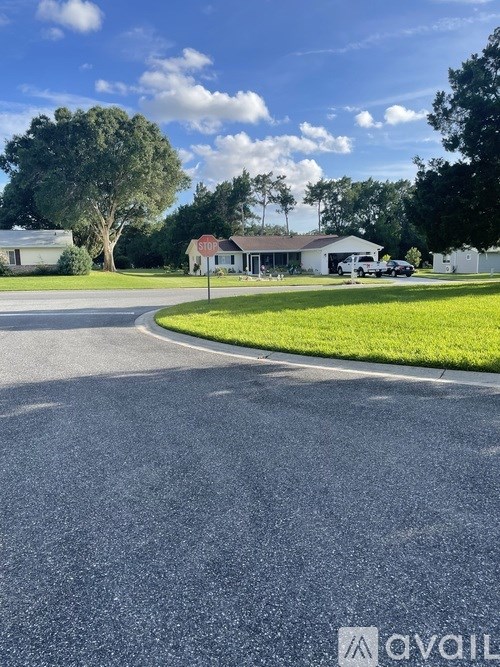 A stop sign is on a pole at a street corner.