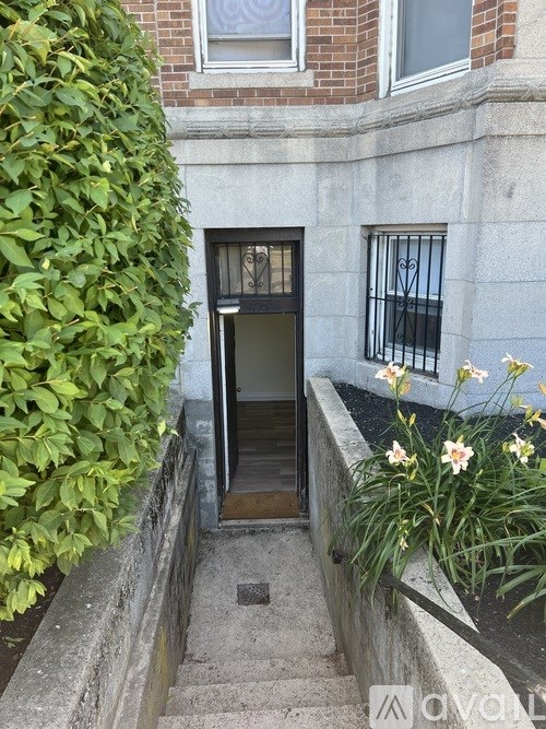 A building with a black door and a window with bars.