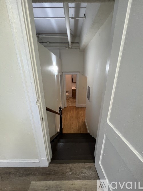 A hallway with a door at the end.