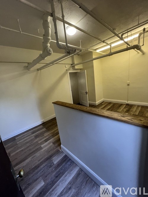 A room with a wooden counter and a door in the background.