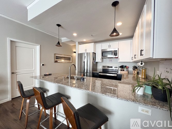 A kitchen with a granite countertop and a sink.