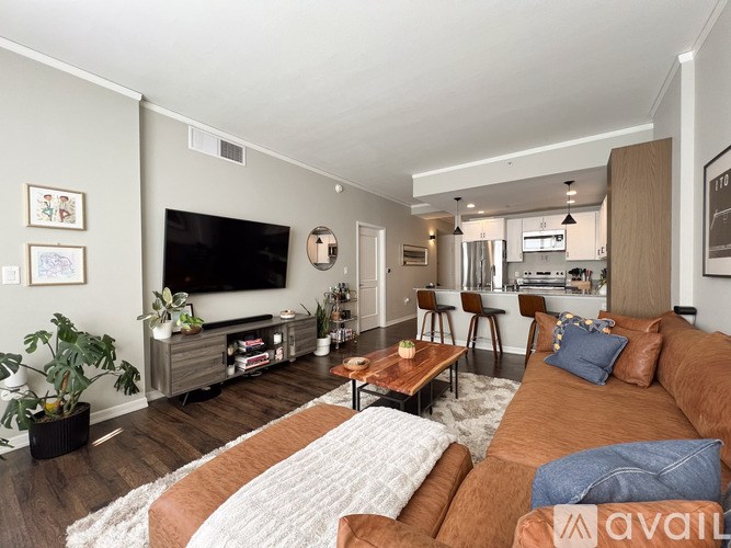 A living room with a brown couch and a television.