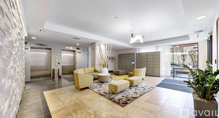 A spacious lobby with a reception desk and seating area.