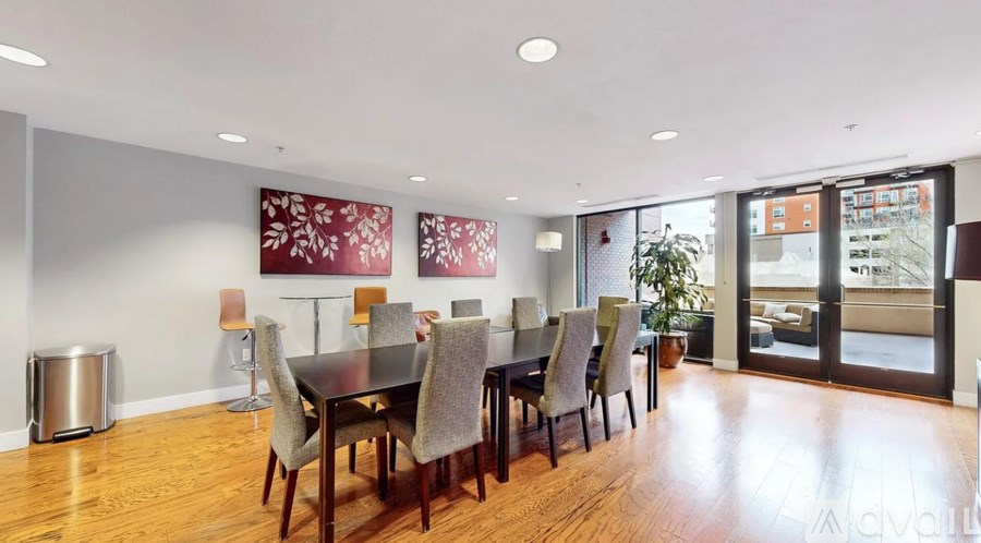 A dining room with a table and chairs.