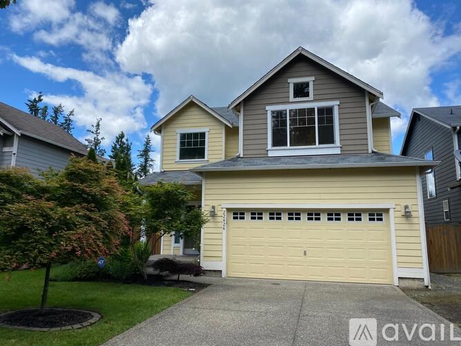 A two-story house with a garage is for sale.