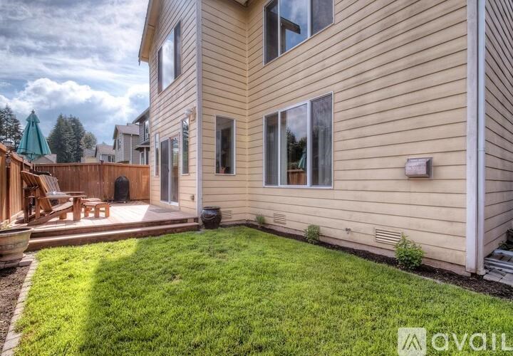 A house with a backyard and a deck.