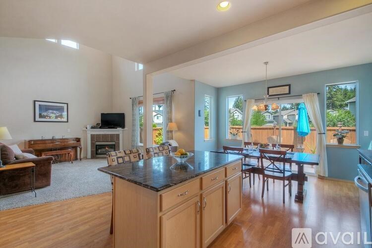 A kitchen with a large island and wooden cabinets.
