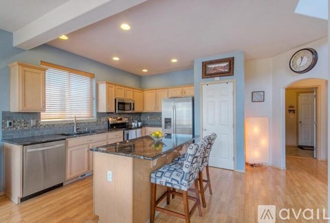 A kitchen with wooden cabinets and a granite countertop.