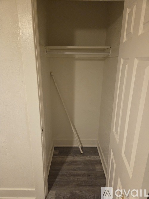 A small, empty closet with a carpeted floor.