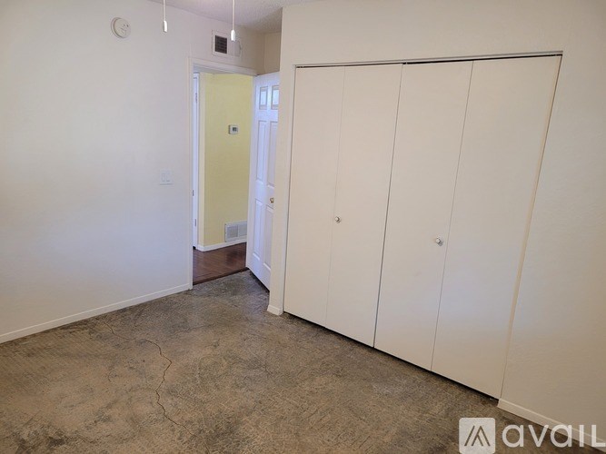 A room with a white door and a white cabinet.