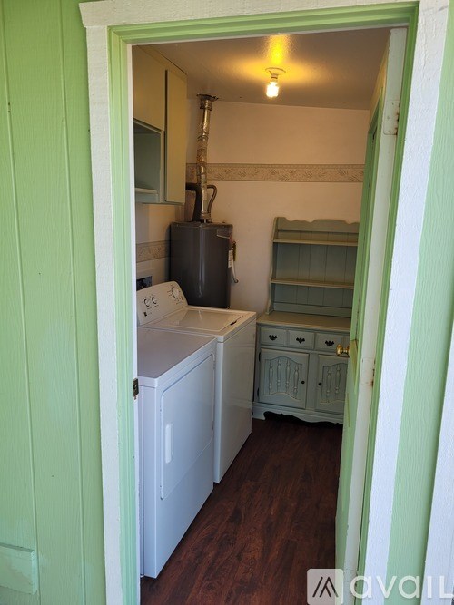 A small laundry room with a washer and dryer.