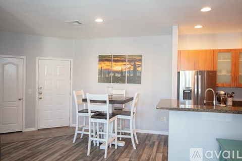 A kitchen with a dining table and chairs.