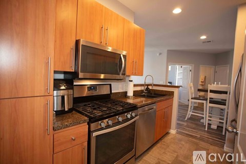 A kitchen with wooden cabinets and stainless steel appliances.