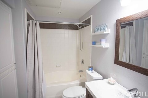 A bathroom with a toilet, sink, and bathtub.