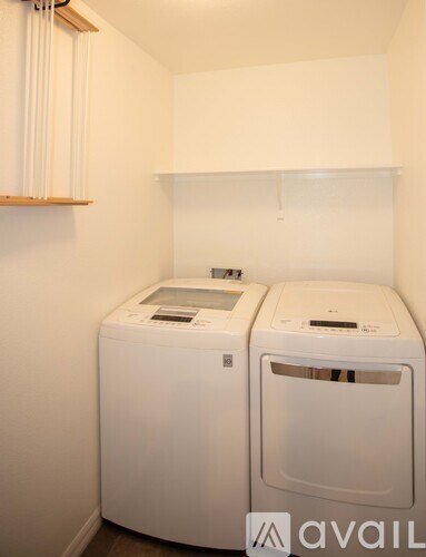 A small room with a washing machine and a dryer.