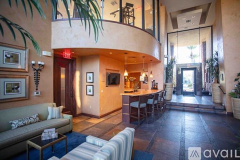 A living room with a couch, a coffee table, and a TV.