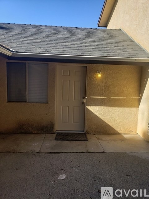 A house with a brown door and a window.