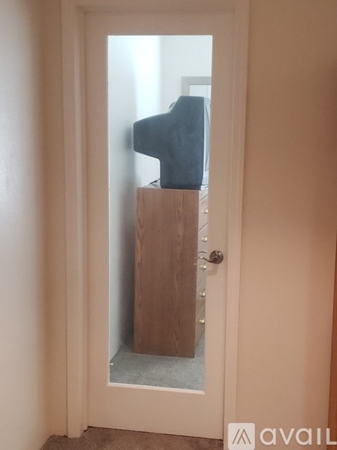 A white door with a glass window and a wooden frame.