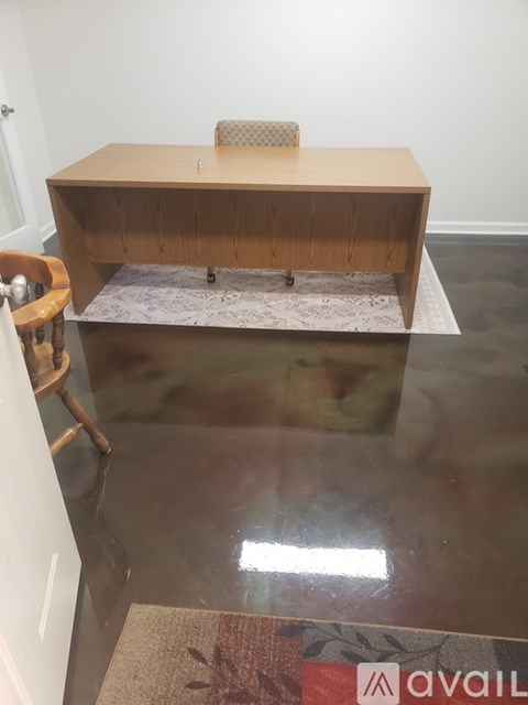 A room with a desk and a chair.