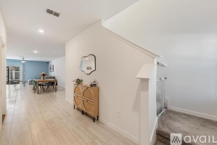 A spacious room with a dining table and chairs.