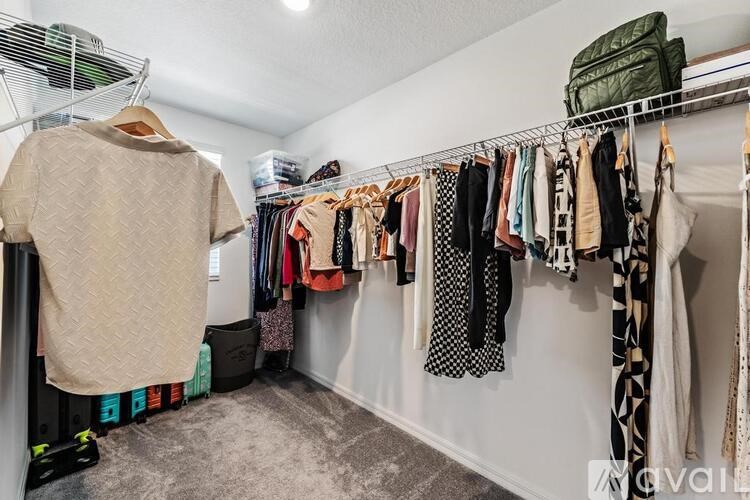 A white wall with clothes hanging on it.