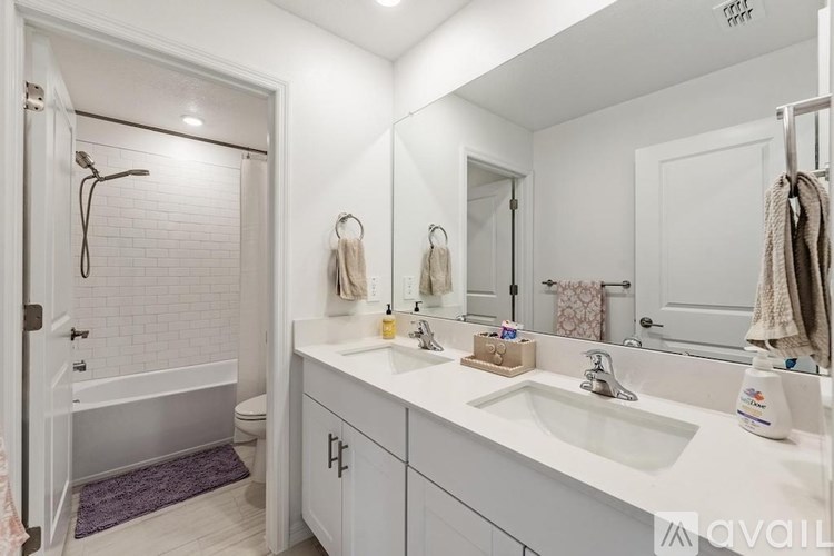 A white bathroom with a white tub and sink.