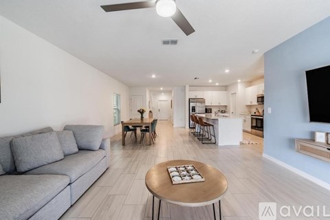 A living room with a grey sofa and a wooden coffee table.