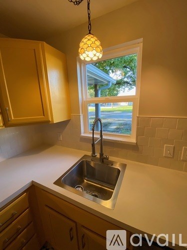 A kitchen with a sink and a window.