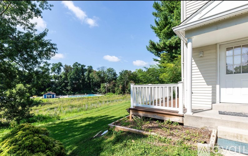 A house with a deck and a pool in the backyard.