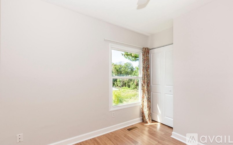 A room with a window and a door.