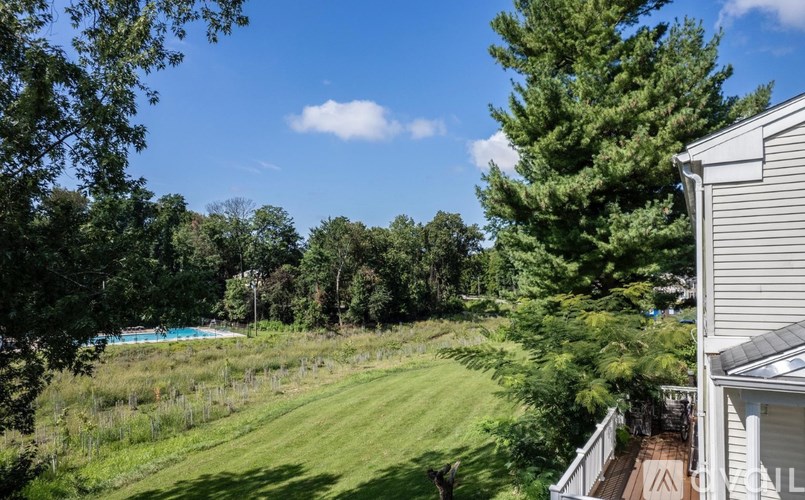 A house with a backyard that has a pool and a fence.