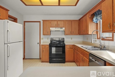 A kitchen with wooden cabinets and a black oven.