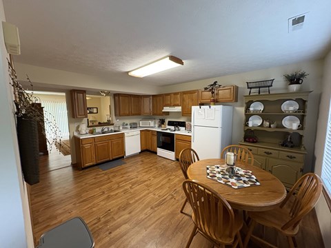 A kitchen with wooden floors and furniture.