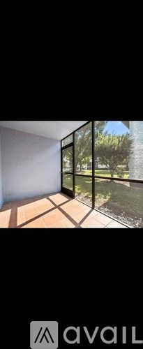 A modern room with a large window overlooking a garden.