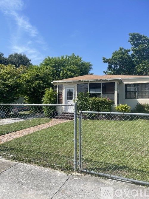 A house with a chain link fence in front of it.