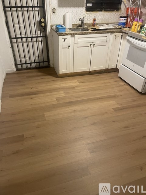 A living room with a glass table and a white cabinet.
