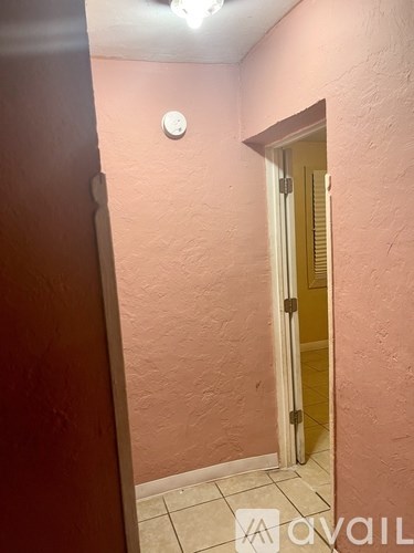 A hallway with a door at the end.