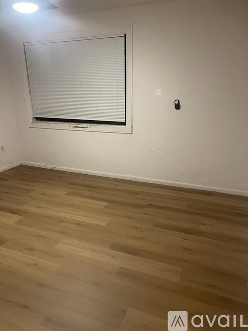 A black hose is hanging on a white door.