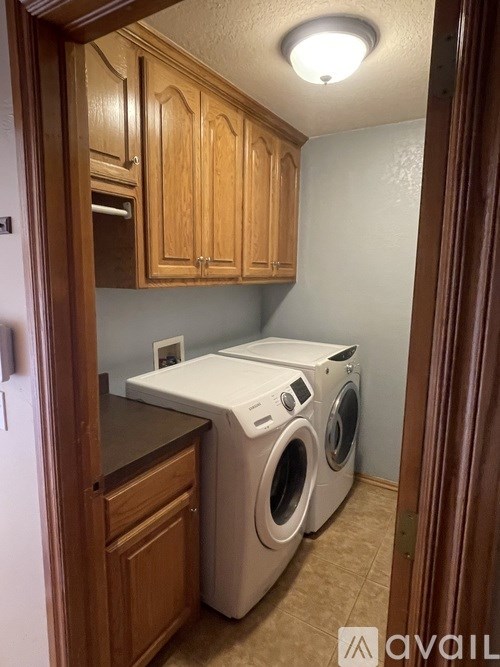 A small laundry room with a washer and dryer.