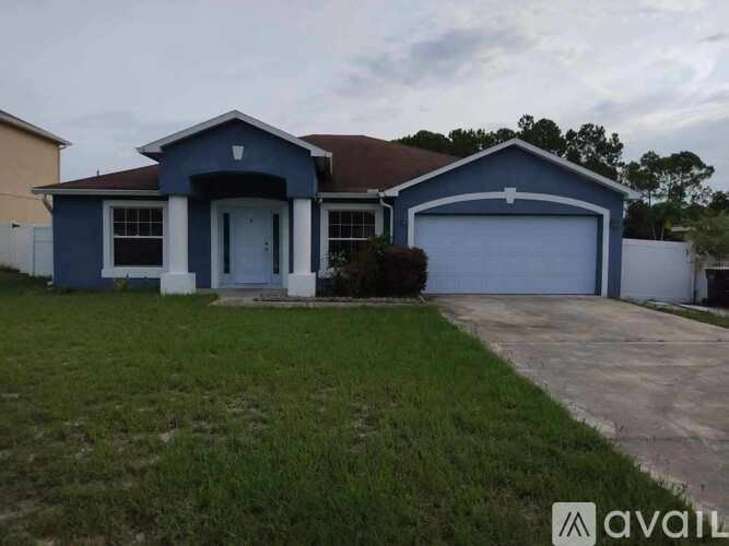 A blue house with a white garage door is available for sale.