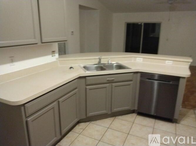 A kitchen with a sink and a dishwasher.