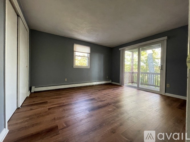 A room with wooden flooring and a window.